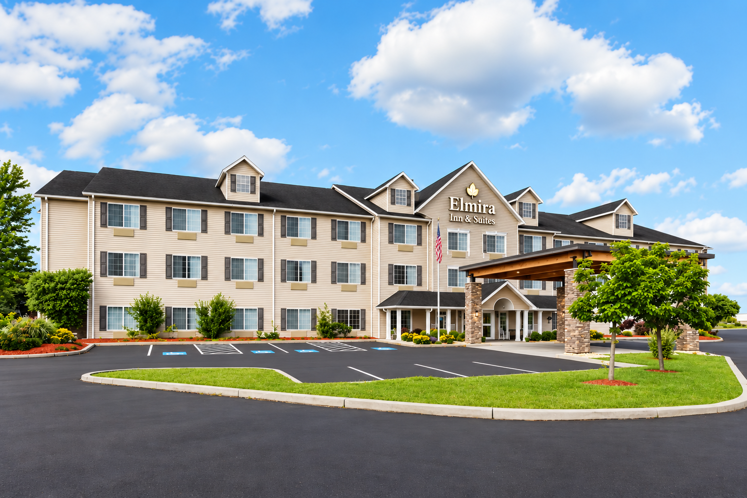 Wide daytime view of Elmira Inn and Suites and its entrance