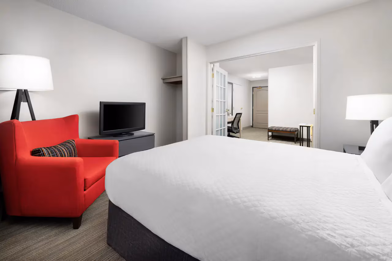Elmira Inn and Suites guest room with one queen bed